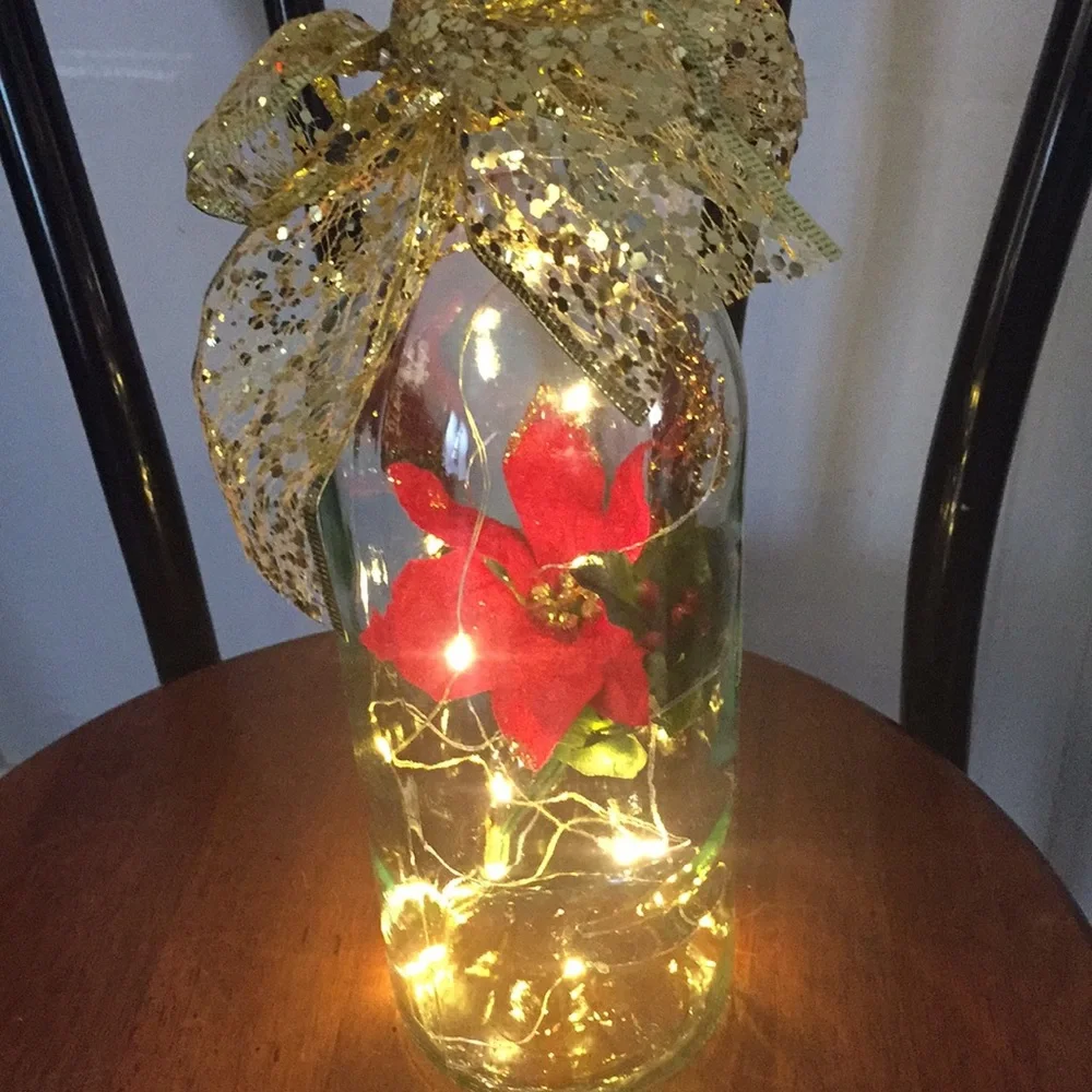 Red poinsettia wine bottle lantern